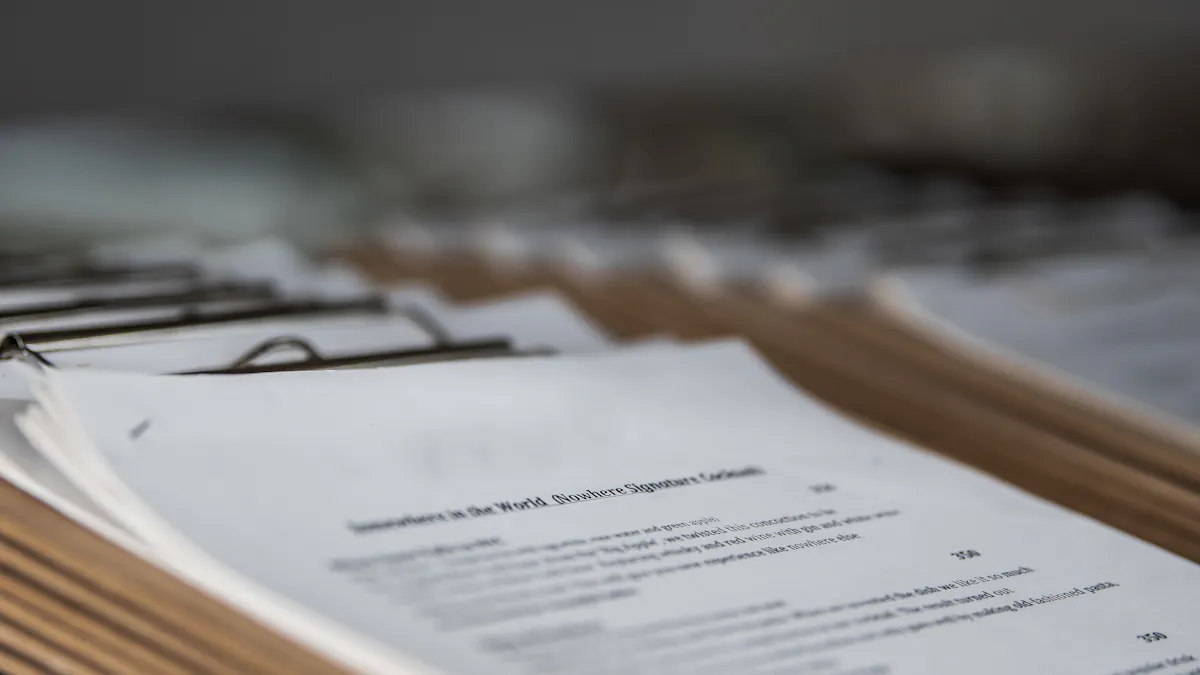 A row of clipboards holding identical printed pages, receding into soft focus.